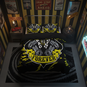 A racing-themed bedding set featuring a duvet cover and two pillowcases with a black and yellow engine graphic and the words 'ENGINE FOREVER' and 'RALLYE', styled in a dark room with racing posters and a toy car.