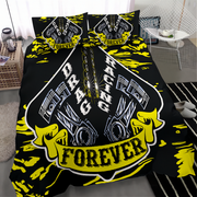 A bedding set featuring a black duvet cover and two matching pillowcases with a bold yellow and white drag racing engine graphic design, styled in a modern bedroom setting.