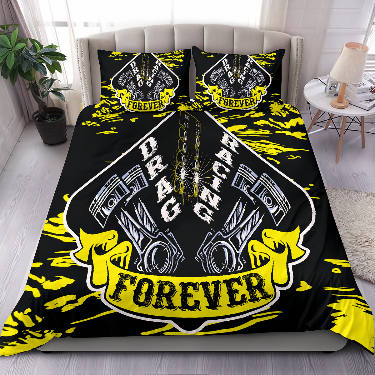 A bed dressed in a black racing-themed bedding set with two matching pillowcases. The duvet and pillows feature a large central shield graphic with pistons, the words 'DRAG RACING', and a yellow banner reading 'FOREVER', surrounded by bright yellow paint-splatter accents.
