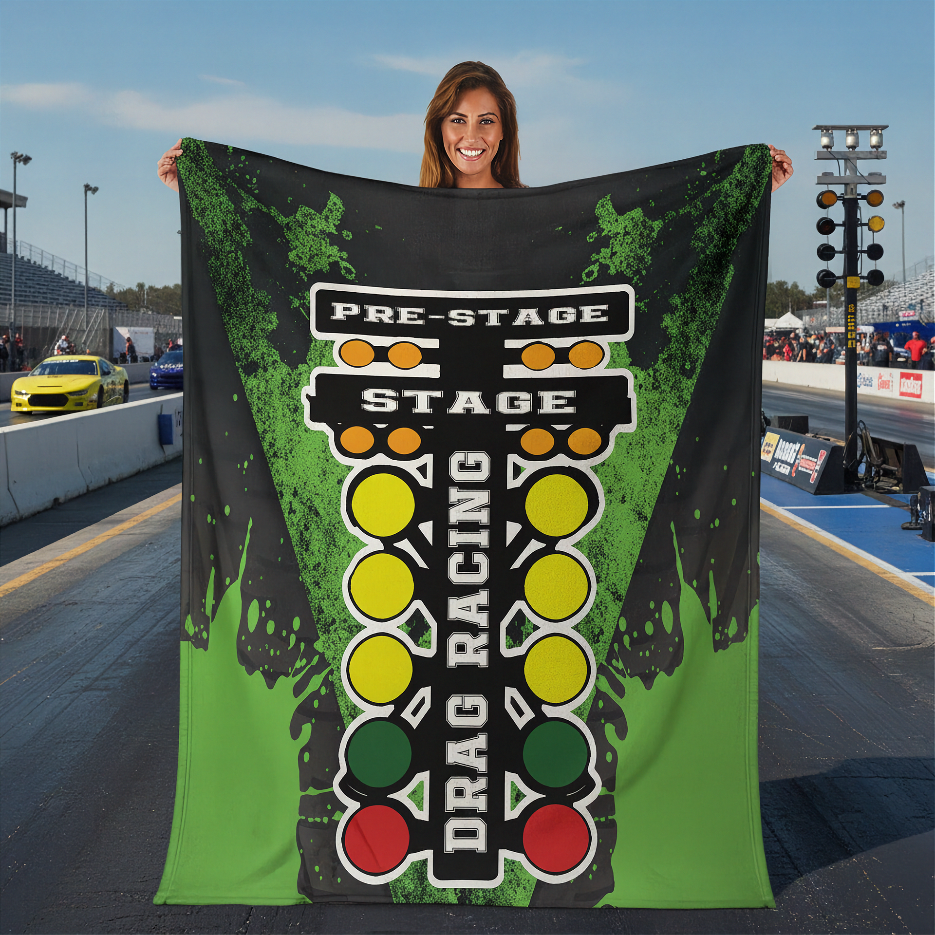 Woman holding a 'Pre-Stage Stage Drag Racing' banner at a race track.