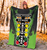 Woman holding a drag racing themed blanket in a forest setting