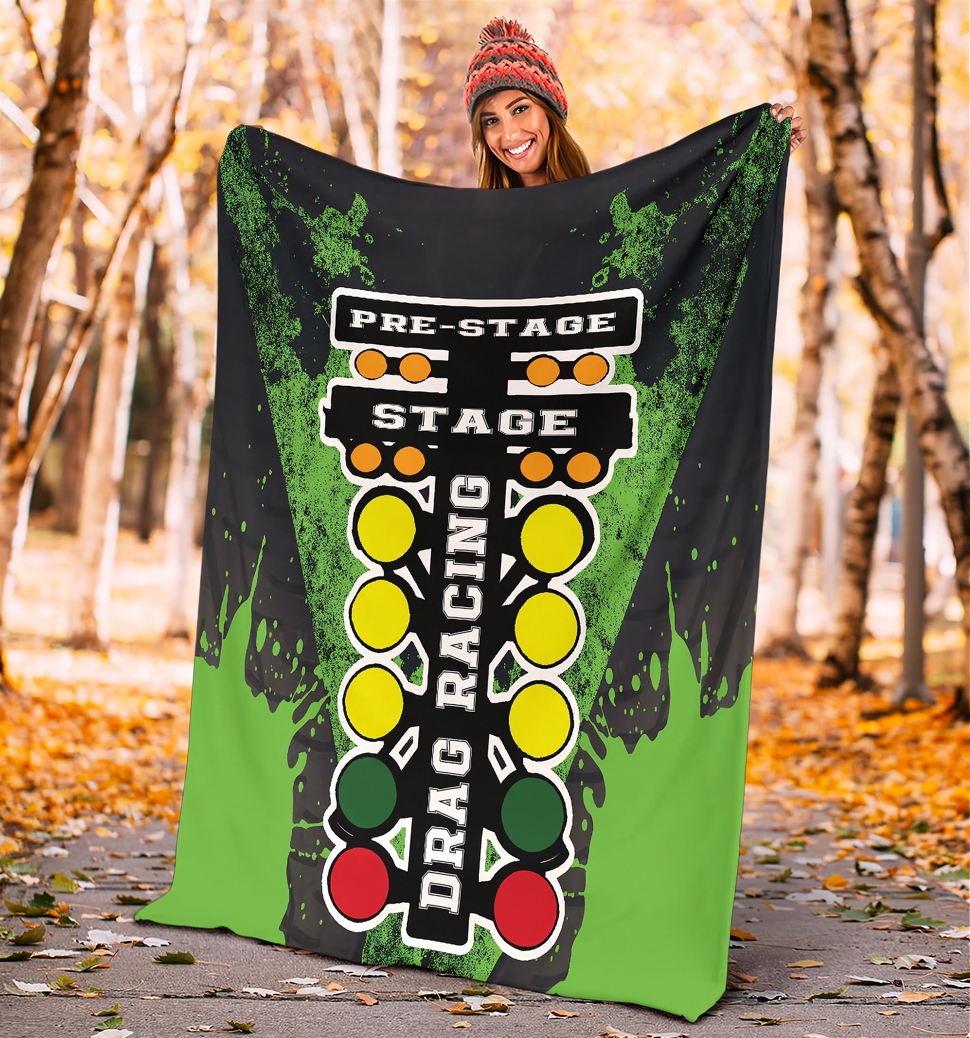 Woman holding a drag racing themed blanket in a forest setting