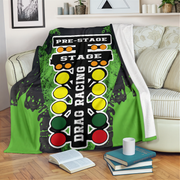 Drag racing themed blanket draped over a couch in a living room.