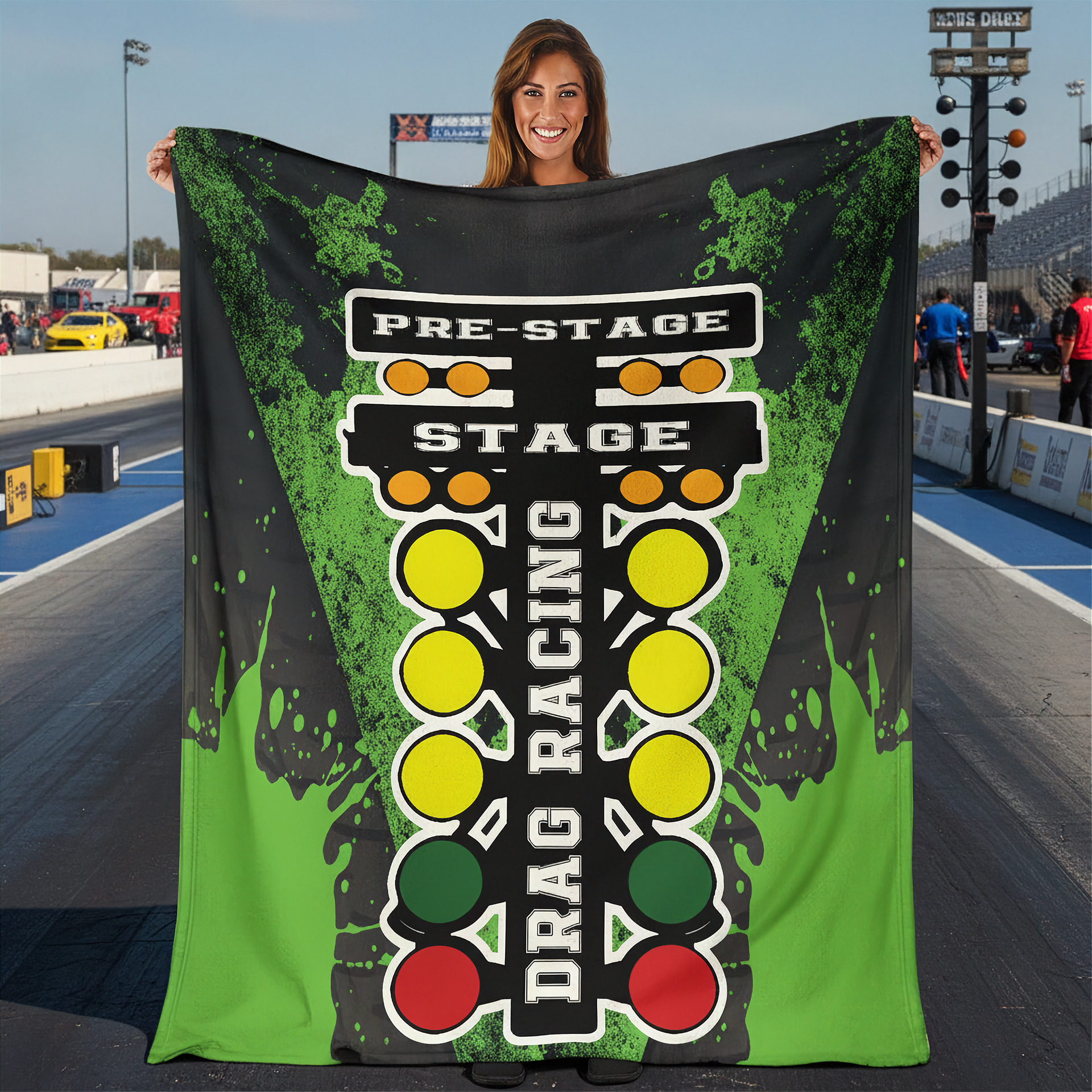 Woman on a drag track holding a green drag racing blanket