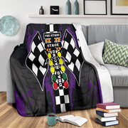 Decorative blanket with drag racing design on a couch in a living room setting