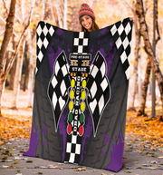 woman holding a colorful blanket with drag racing design in an autumn setting