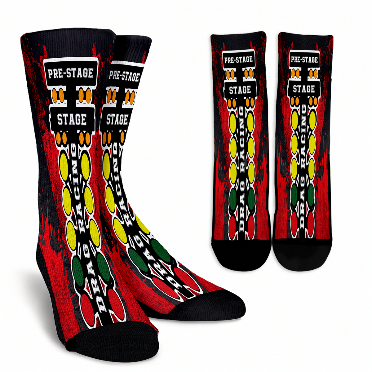 A pair of crew socks shown from the front and side on a white background, with a second pair shown from the back. The socks feature a black base with a red distressed background, a central vertical graphic of yellow, green, and red oval shapes outlined in white, and white text reading 'PRE-STAGE' and 'STAGE'.