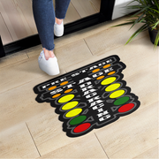 Doormat with 'Pre-Stage Staging' text and traffic light design on a wooden floor.