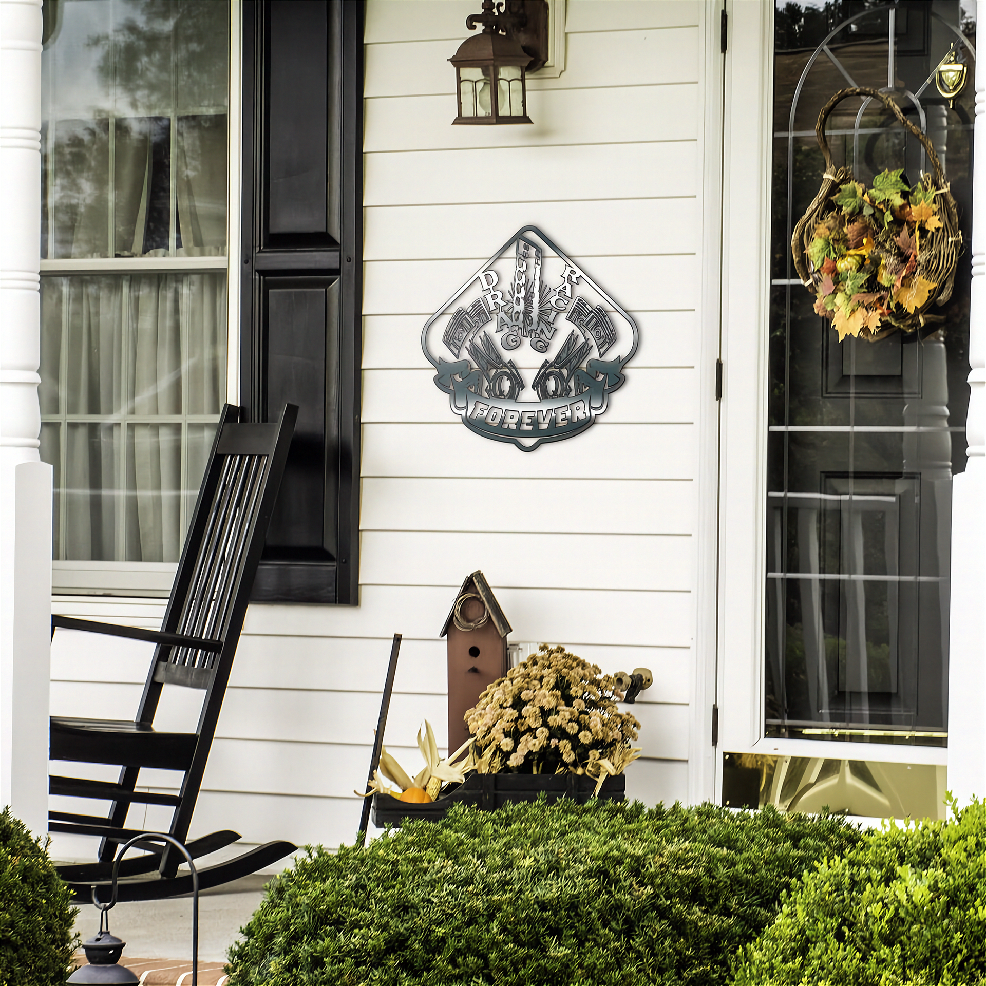Front porch with a rocking chair, decorative drag racing sign, and wreath on a white house.