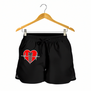 Black athletic shorts with a red heart and abacus graphic on the front, hanging from a wooden hanger against a white background.