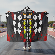 Person holding a drag racing themed hooded blanket on a racetrack