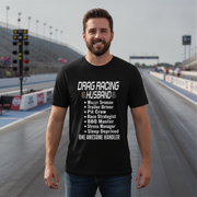 Man wearing a black t-shirt with drag racing text on a race track background