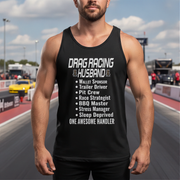 Man wearing a black tank top with drag racing husband on a race track background