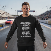 Man wearing a black sweatshirt with drag racing husband on a race track