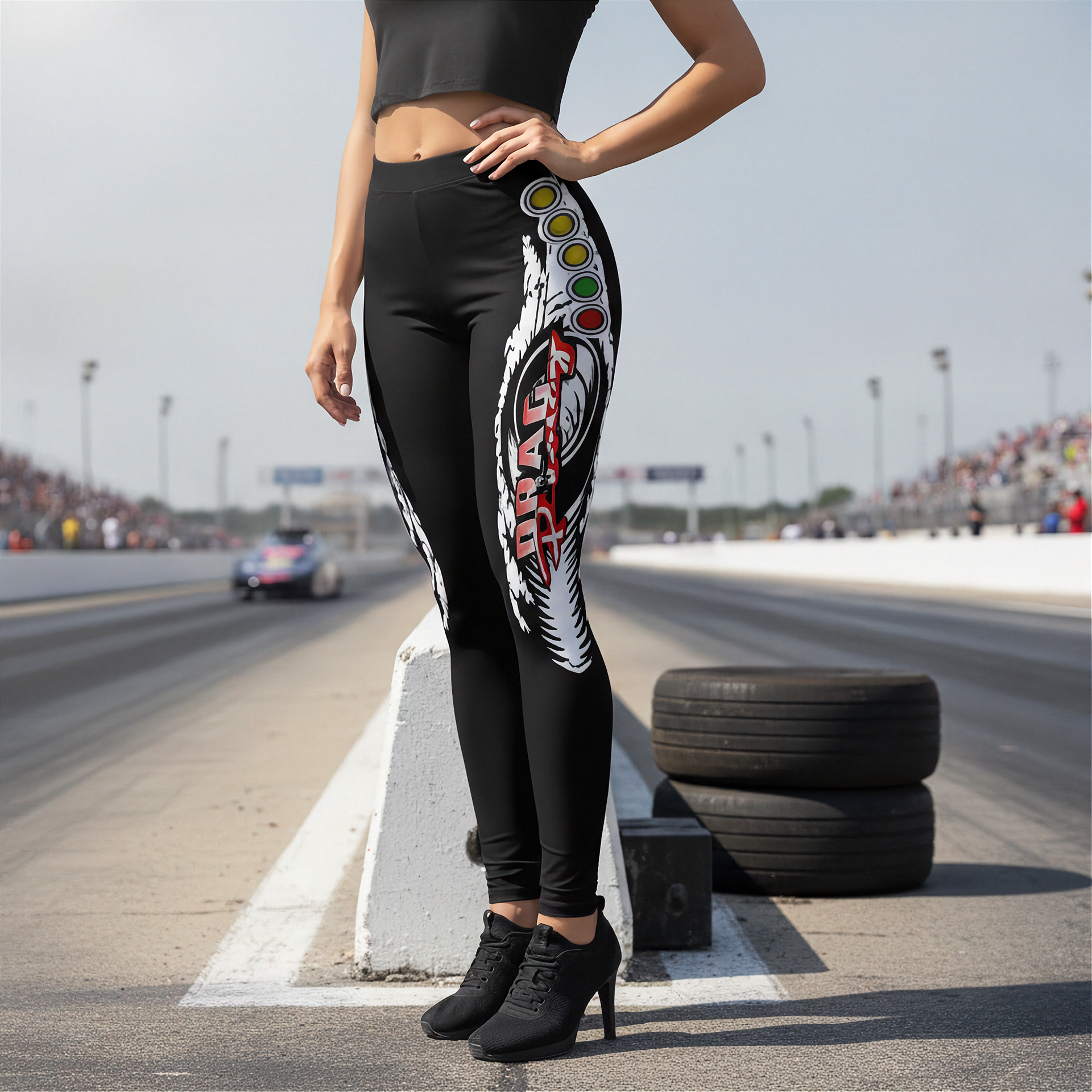 Woman wearing black leggings with drag racing design on a race track