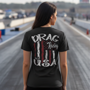 Person wearing a black t-shirt with 'Drag Racing Made in USA' design on a racetrack.