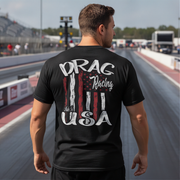 Man wearing a black t-shirt with 'Drag Racing USA' design on a racetrack.