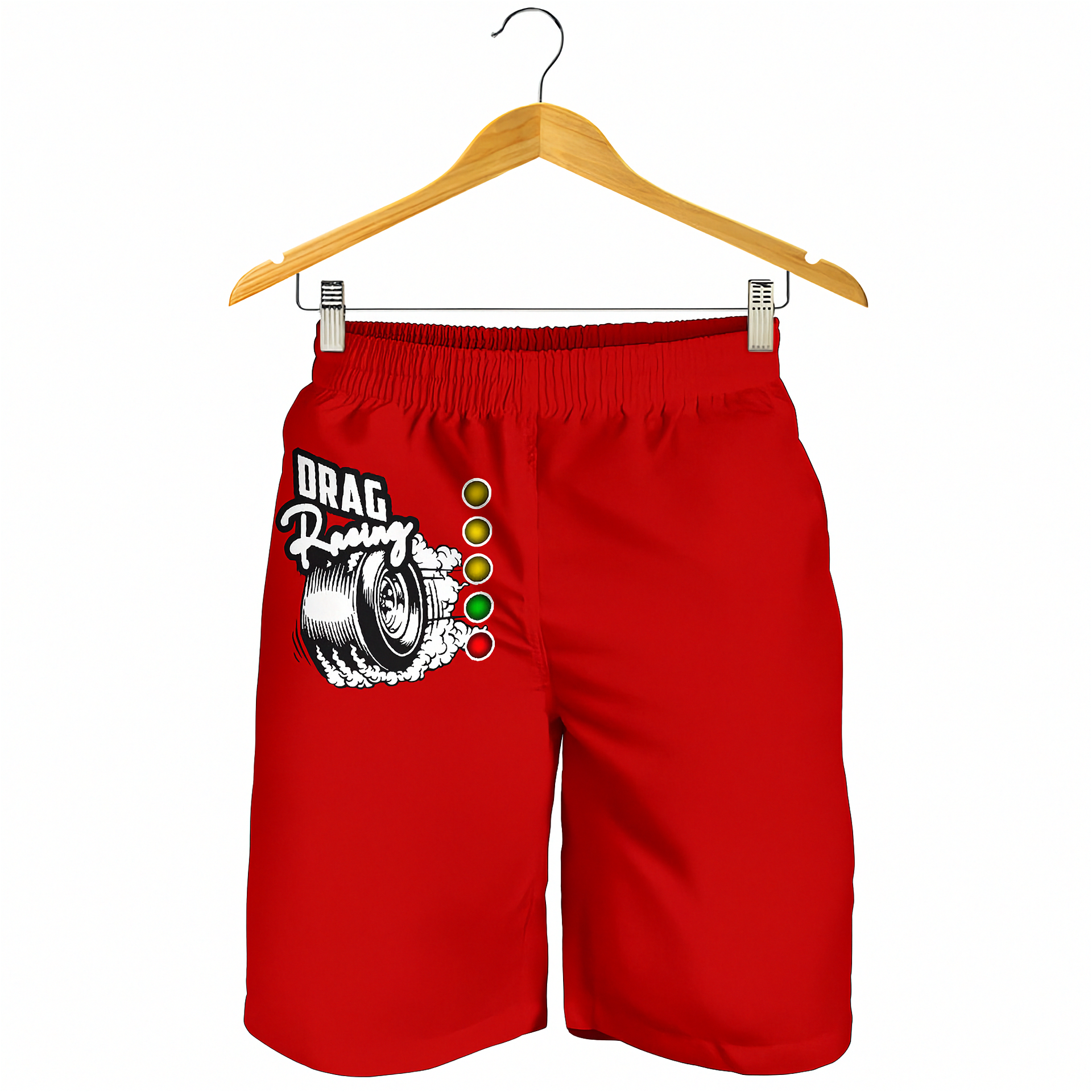 Red athletic shorts with a 'Drag Racing' tire graphic and a vertical green, yellow, and white light bar design on the left leg, hanging from a wooden hanger against a white background.