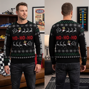 A man modeling a black Christmas sweater in a split front and back view. The sweater features a green and white holiday pattern with 'HO-HO-HO' in red across the chest, white reindeer silhouettes, and 'SKINNY BENT' printed down the sleeves.