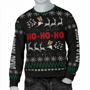 A black long-sleeve Christmas sweater with a festive holiday print featuring white snowflakes, green zig-zag patterns, reindeer, Santa Claus, and red 'HO-HO-HO' text, shown on a gray mannequin torso.