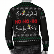 A black Christmas sweater with a festive holiday design, shown from the back on a mannequin. The design features 'HO-HO-HO' in red pixelated text, Santa Claus sleighing with reindeer, white snowflakes, and green and white geometric borders.