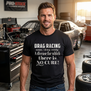 a man standing in a garage wearing black shirt with "Drag Racing Noun" design printed on high-quality, highlighting the definition of a true drag racing enthusiast.