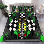 A drag racing-themed bedding set featuring a duvet cover and two matching pillowcases with a black and white checkered track design, green paint splatters, and racing lights, displayed on a bed in a modern bedroom setting.
