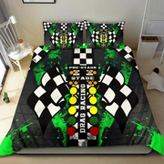 A drag racing-themed bedding set featuring a duvet cover and two matching pillowcases with a black and white checkered flag motif, green paint splatters, and a central vertical graphic with yellow, green, red, and white elements reading 'PRE-STAGE', 'STAGE', and 'DRAG RACING'. The set is displayed on a bed in a bedroom setting.