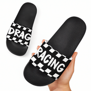 Black slides with panda design held by a hand on a white background