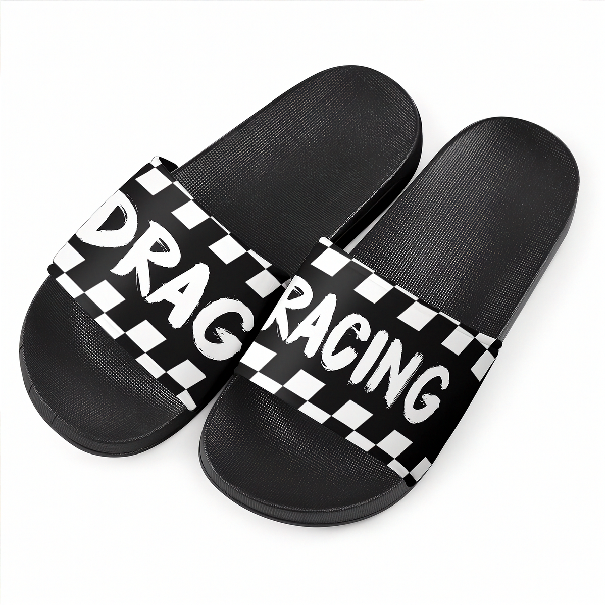 A pair of black slide sandals with a wide strap featuring a black and white checkered pattern and the words 'DRAG RACING' in white.