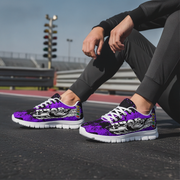 Person wearing purple and black sneakers with white soles on a track.