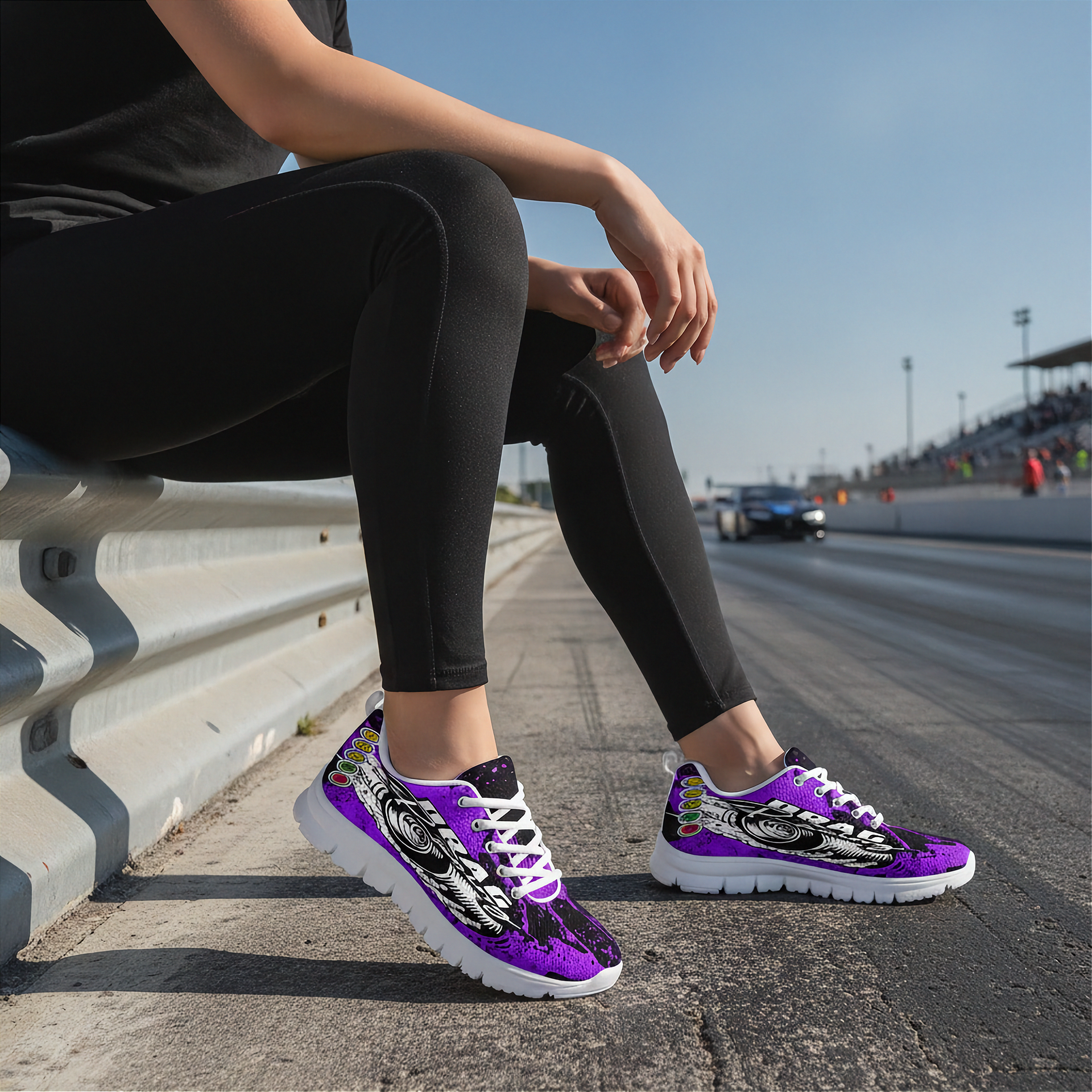 Person wearing purple sneakers with black and white designs on a race track.