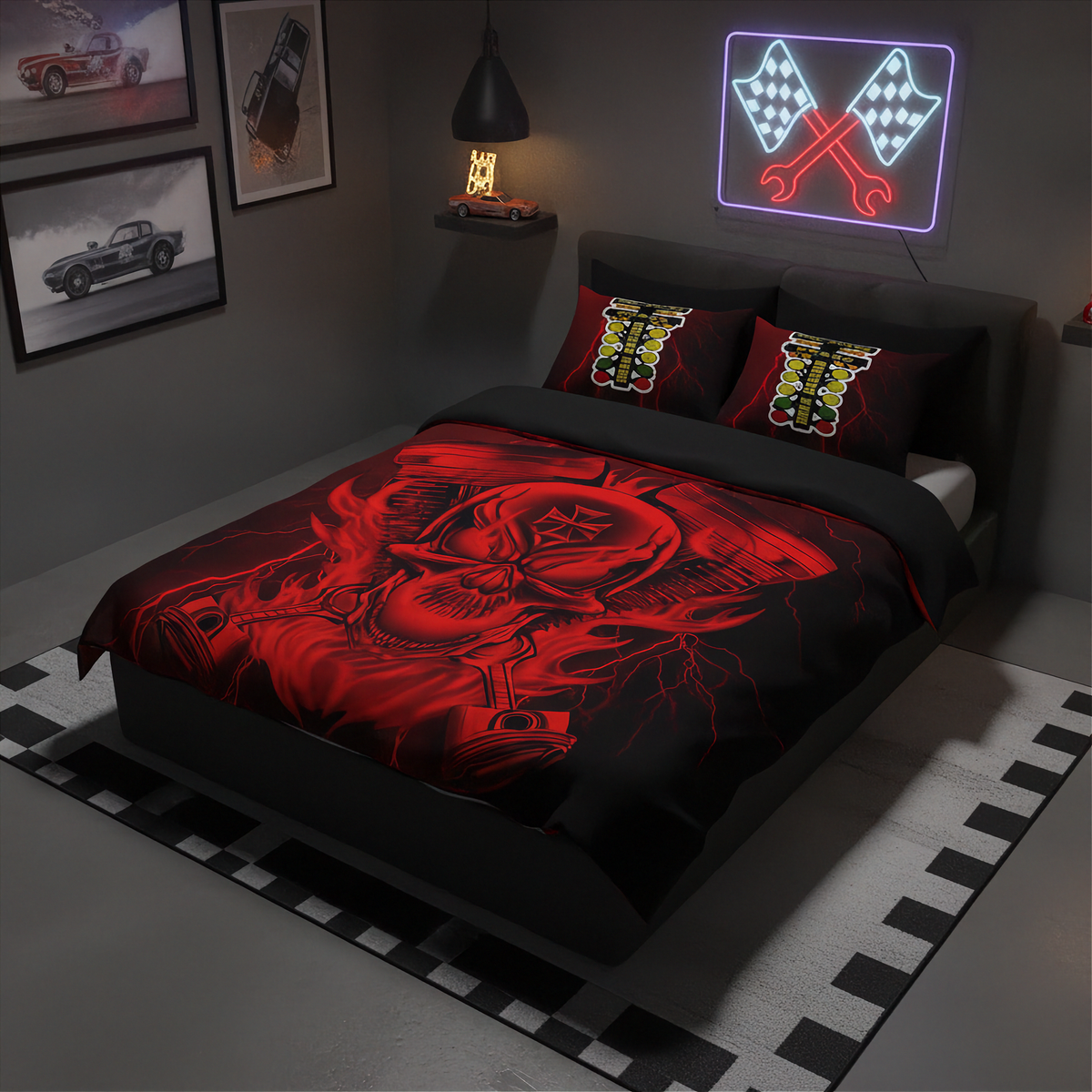 A bed dressed in a black and red racing-themed bedding set with a large skull graphic on the duvet and matching patterned pillows, styled in a dark modern bedroom with racing wall art and a neon sign.