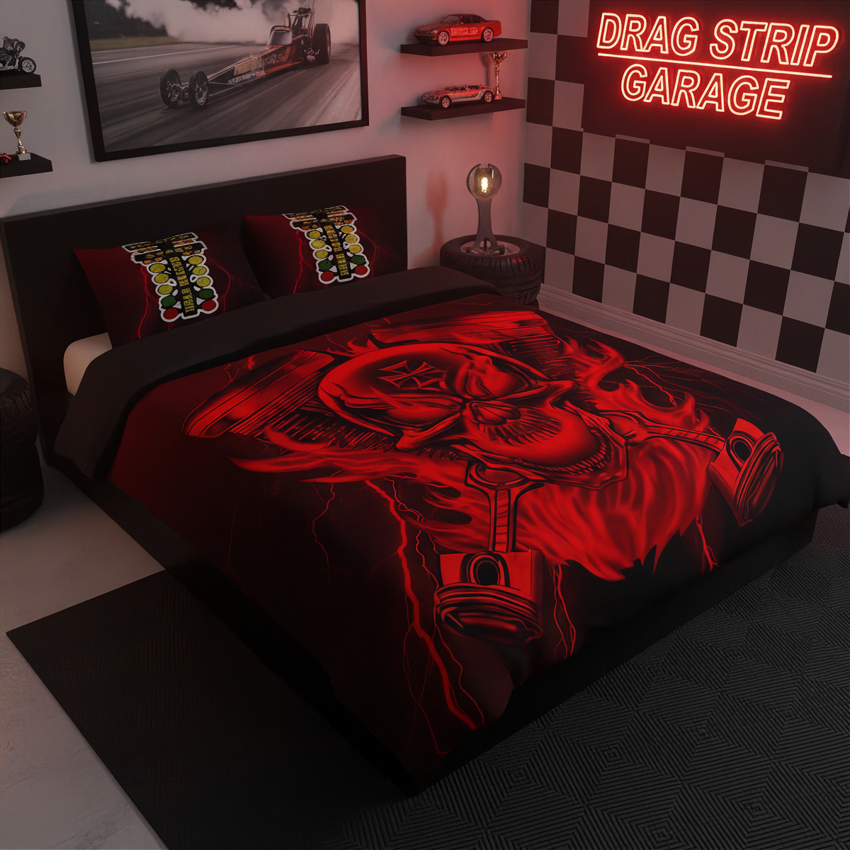 A bed dressed in a black and red drag strip themed bedding set, featuring a large red and black skull graphic with pistons and exhausts. The room is styled with a checkered wall, a neon sign reading 'DRAG STRIP GARAGE', and drag racing memorabilia.