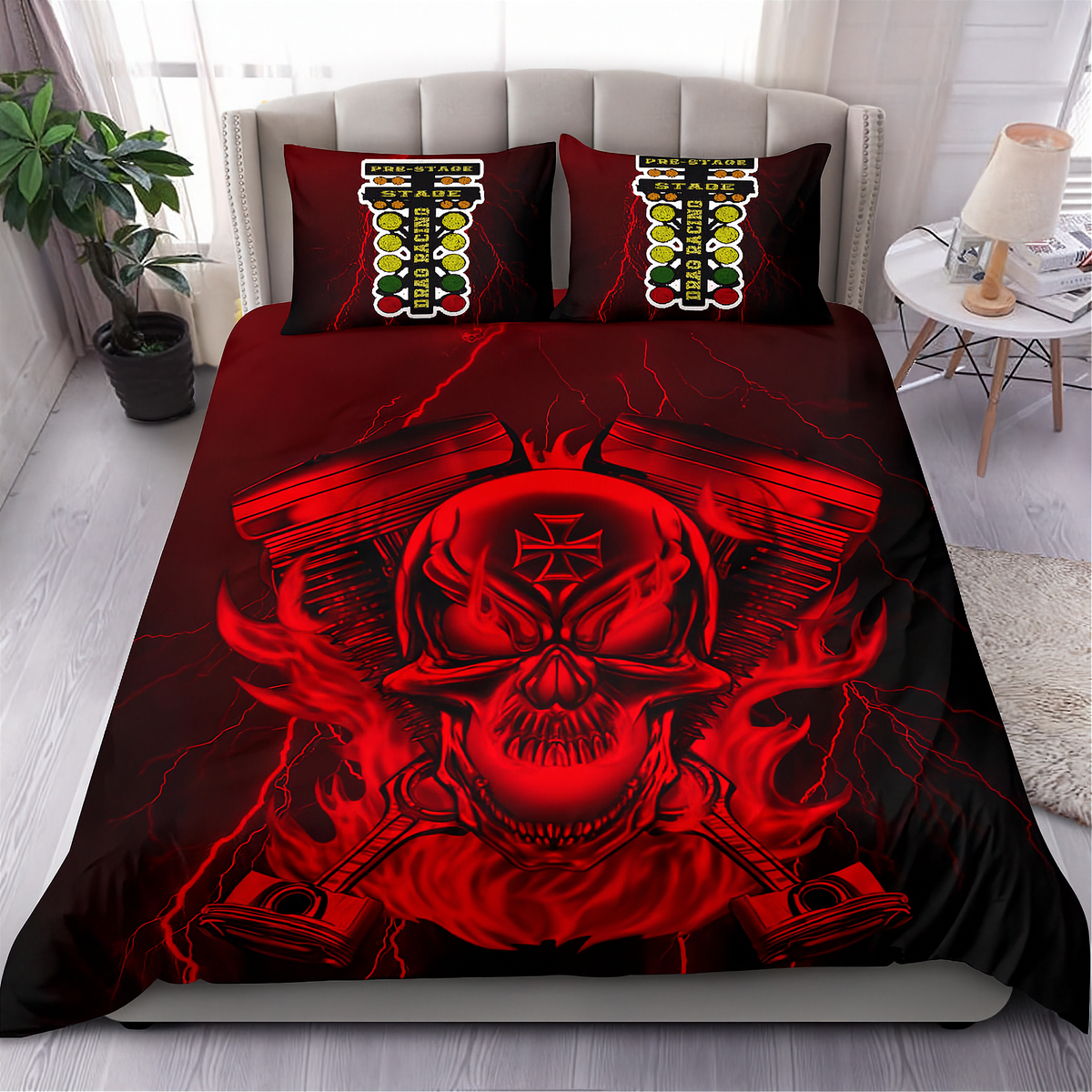 A bed dressed in a red and black graphic bedding set featuring a large skull over crossed pistons with lightning effects, plus two matching pillowcases with a repeating vertical stripe pattern, shown in a styled bedroom setting.