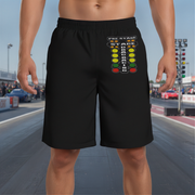 Black athletic shorts with a colorful 'Pre-Stage Race Track Lights' graphic on the left leg, modeled on a person standing on a racetrack.