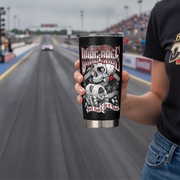 A person holds a black insulated tumbler with a racing graphic in front of a blurred drag strip background. The tumbler features a skull, gears, and the text 'Drag Race'.
