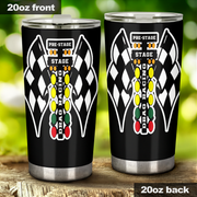 Two 20oz black insulated tumbler cups shown from front and back, featuring a checkered flag and race lights graphic with the words 'PRE-STAGE' and 'STAGE'. The tumbler lids are clear, and the cups are photographed outdoors on a wooden surface with a blurred green background.