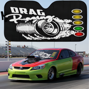 Car with drag racing-themed sunshade on a race track background