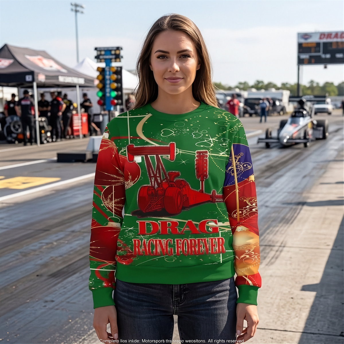 A woman stands on a drag racing track wearing a green crewneck sweatshirt with a red and gold drag racing graphic and the text 'DRAG RACING FOREVER'.
