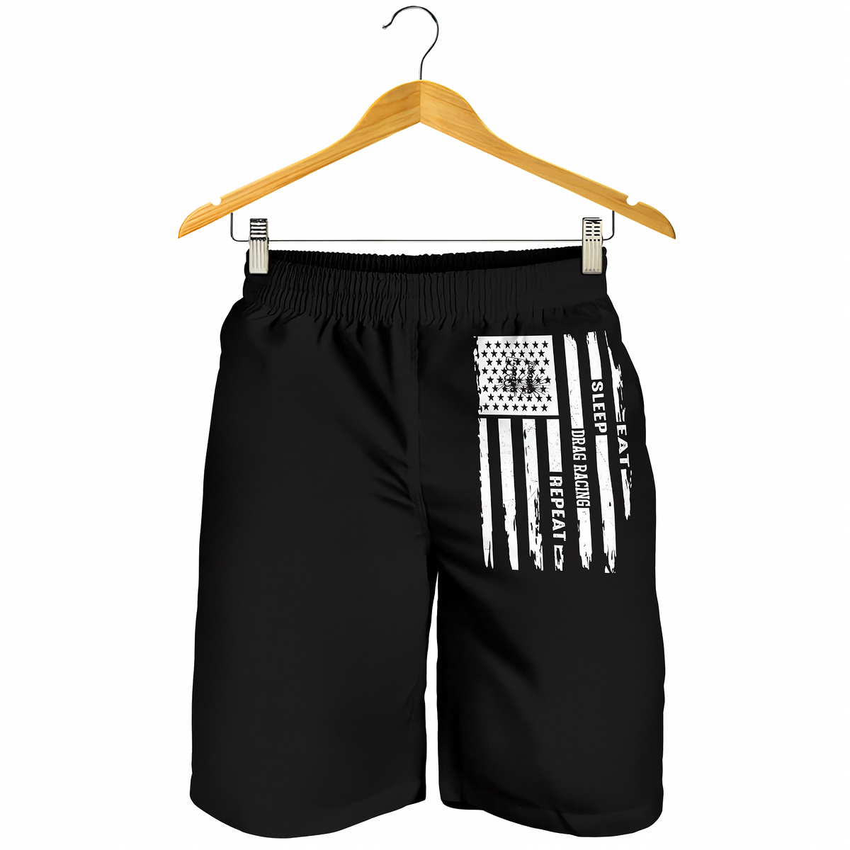 Black athletic shorts with a distressed white American flag graphic and the words 'EAT SLEEP DRAG RACING REPEAT' hanging from a wooden hanger against a white background.