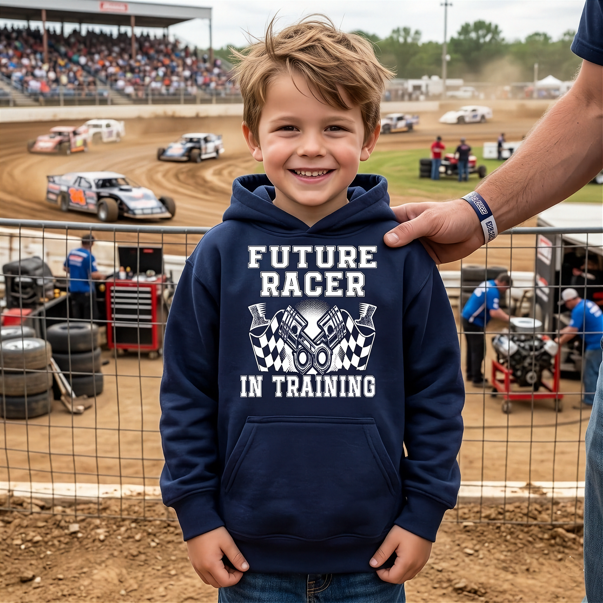 Child wearing a 'Future Racer in Training' hoodie at a dirt track event.
