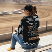 Woman sitting on a race track wearing a checkered jacket with text.