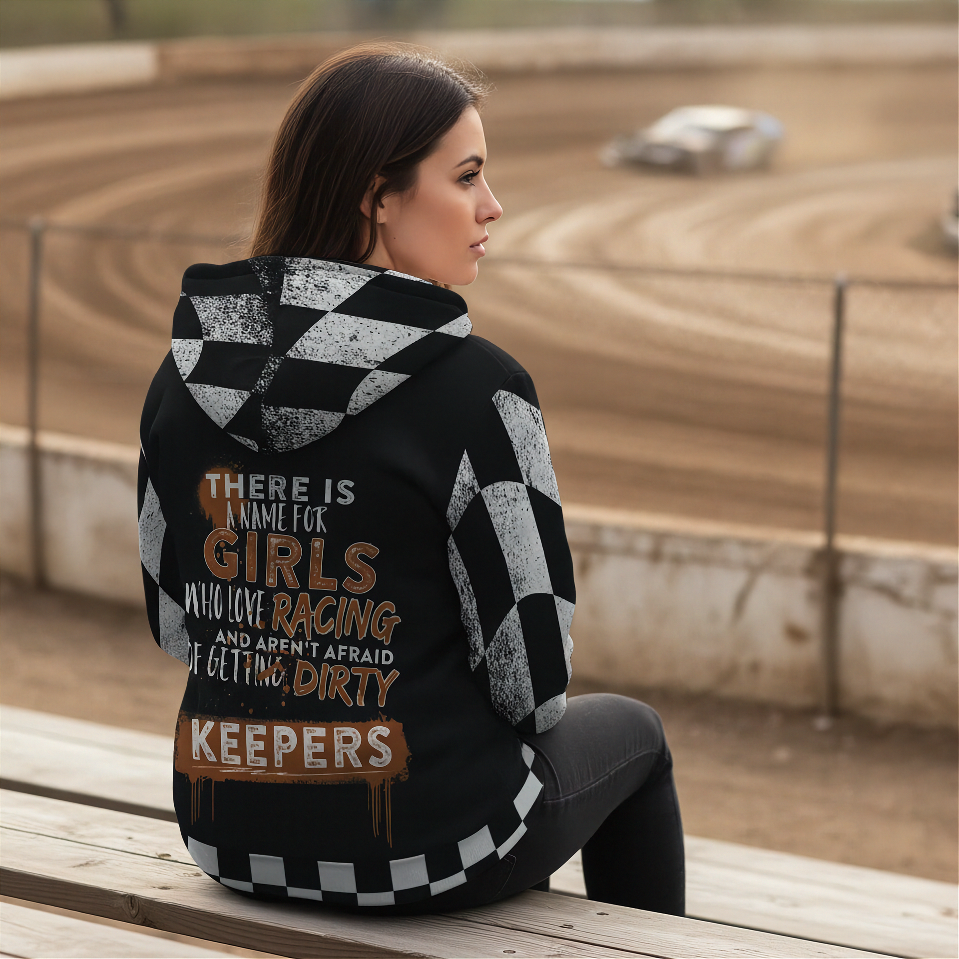 Woman wearing a sherpa hoodie with racing text on the back at a dirt track