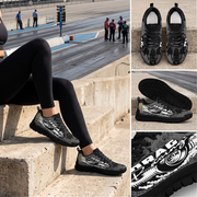 A collage showing black and gray graphic sneakers worn by a person sitting on concrete steps, with additional close-up views of the shoes. The shoes have a glossy black upper with gray abstract graphics and white text on the side.