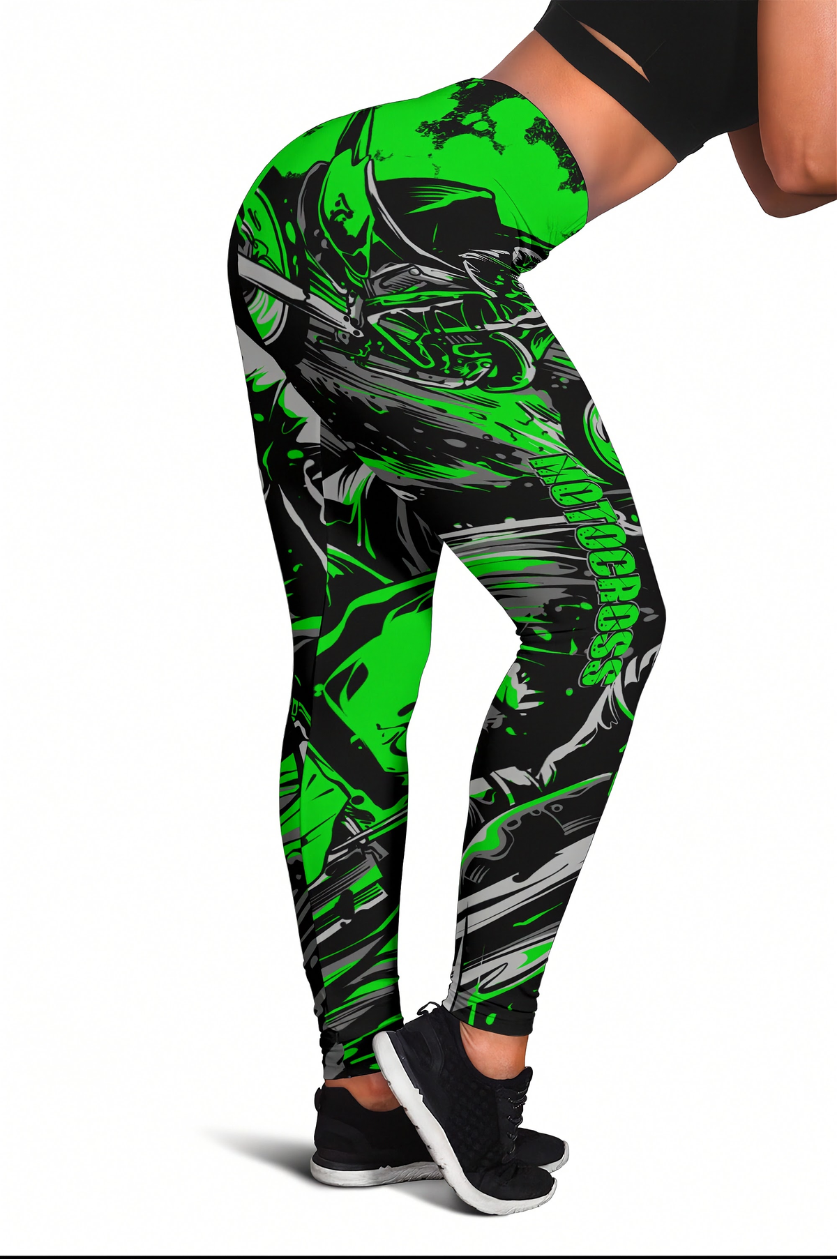 A person wearing high-waisted leggings with a bold neon green and black graphic print, shown from the waist down against a plain white background.