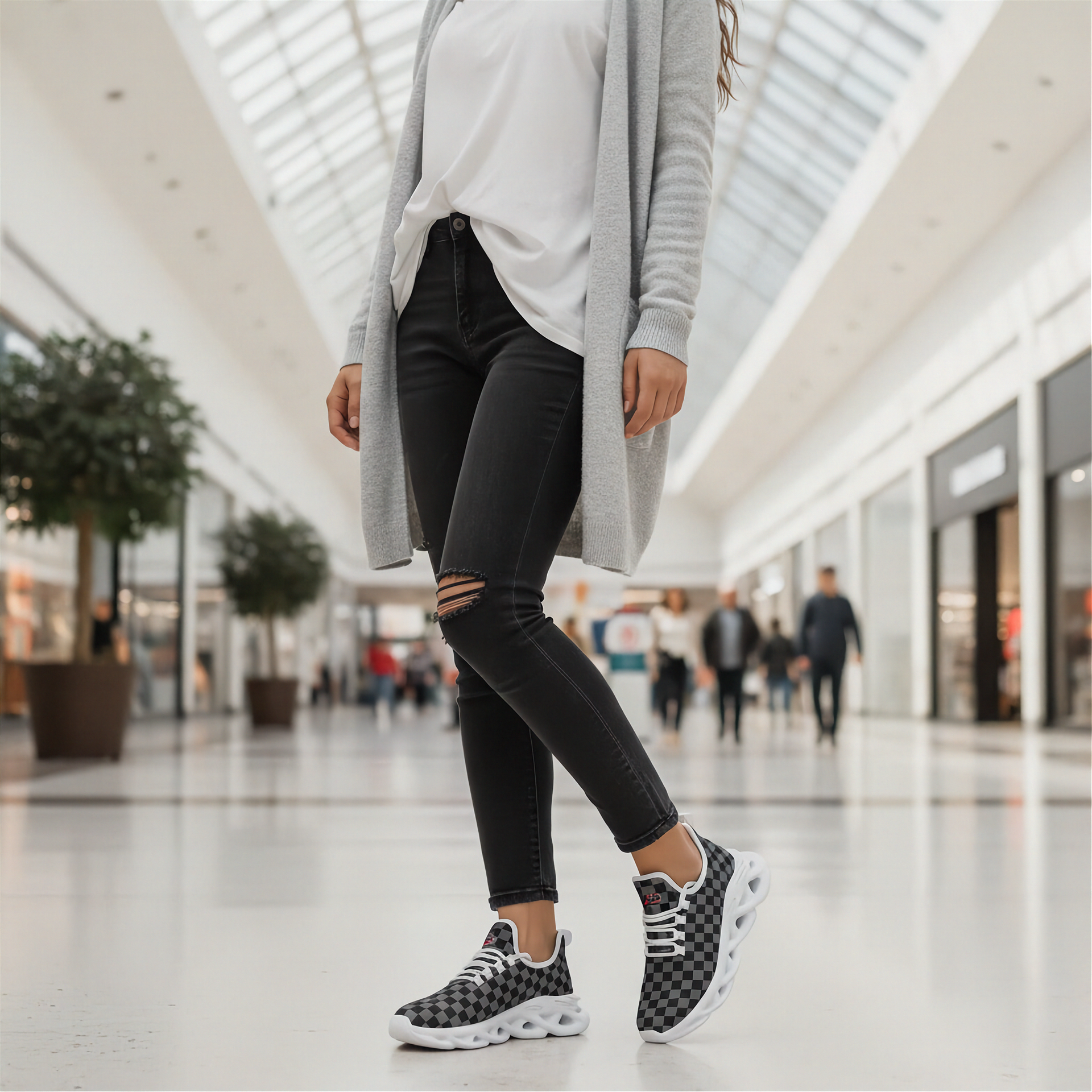 Man wearing black ripped jeans and checkered shoes in a mall setting