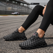 Woman wearing checkered sneakers on a race track