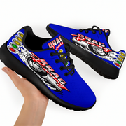 A pair of blue and black drag racing themed sneakers with a graphic design, held by a hand against a white background.