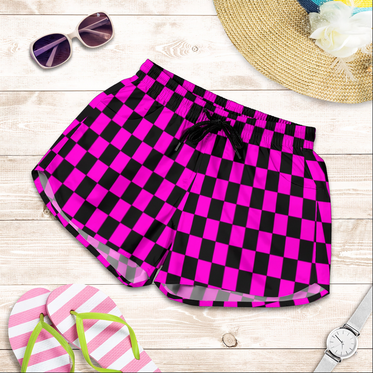 High-performance women's athletic shorts featuring a bright pink and black checkered pattern, designed with an elastic drawstring waist and functional side pockets.
